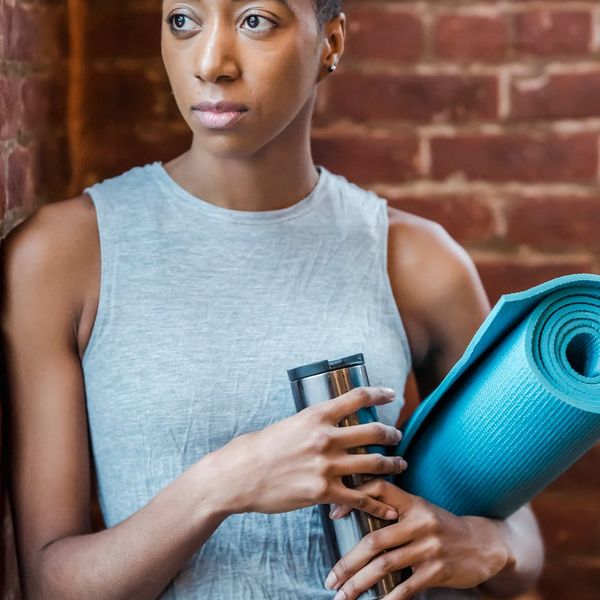 Close-up of a yoga mat and water bottle in a calm setting.